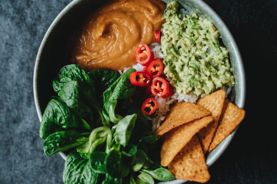 Delicious vegan bowl featuring avocado, rice, and fresh greens perfect for a healthy meal.
